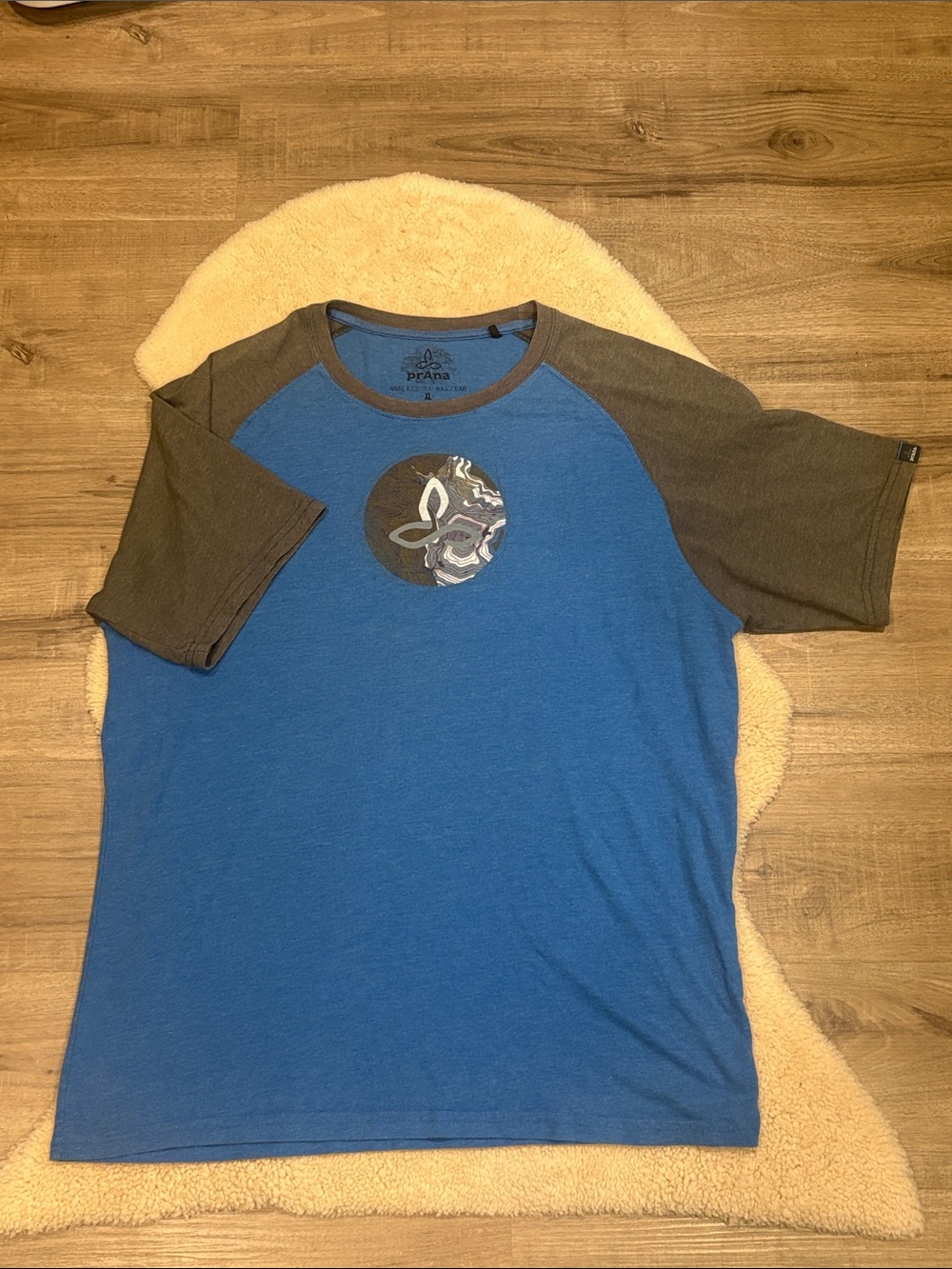 Prana Blue Tee with Gray Raglan Sleeves and Chest Emblem